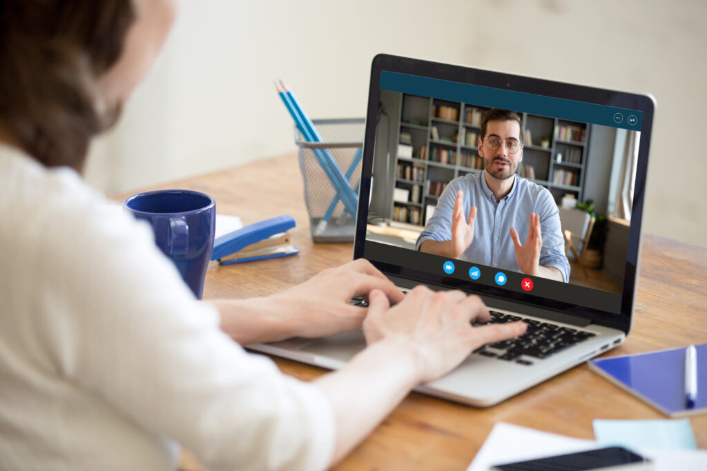 Female talking to a man over a video call o her laptop