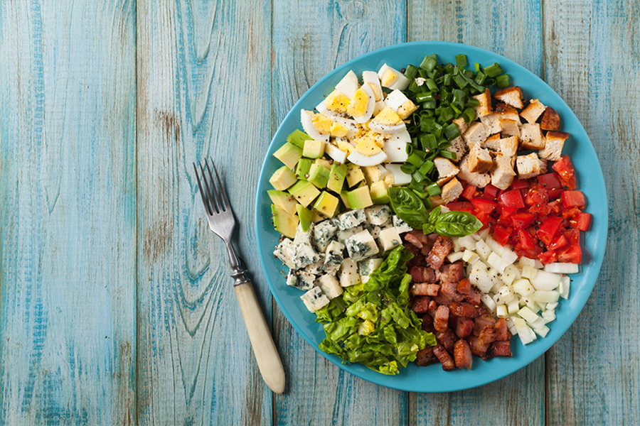Cobb Salad with chicken, egg, avocado, tomatoes, cheese and other toppings
