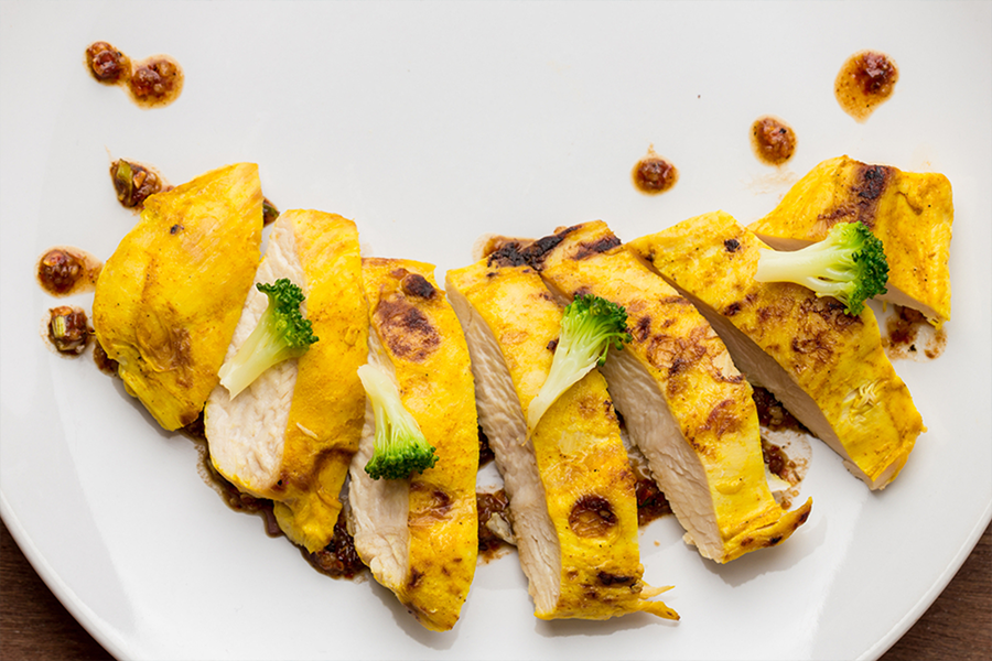 Sliced Coconut, Turmeric & Ginger-Marinated Chicken Breast With Peanut Sauce and broccoli
