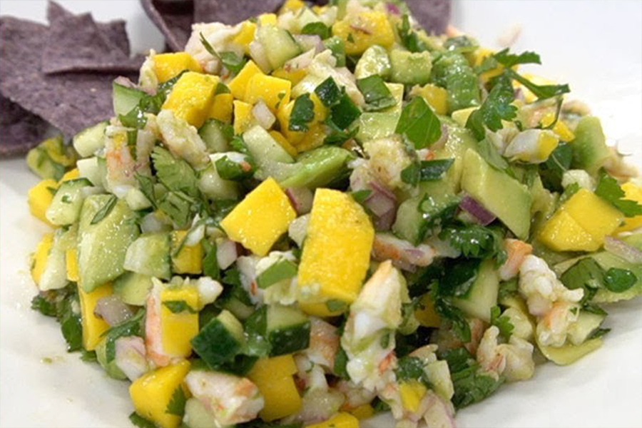 Pile of Shrimp and Mango Ceviche with blue corn tortilla chips