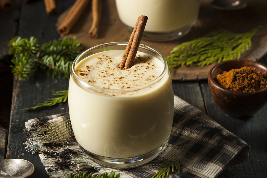 Glass cup of Eggless "Eggnogg" Smoothie with a cinnamon stick