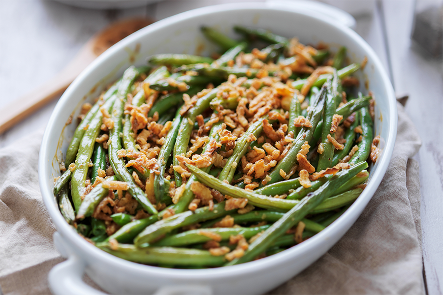 Baking dish of green bean casserole topped with crispy onions