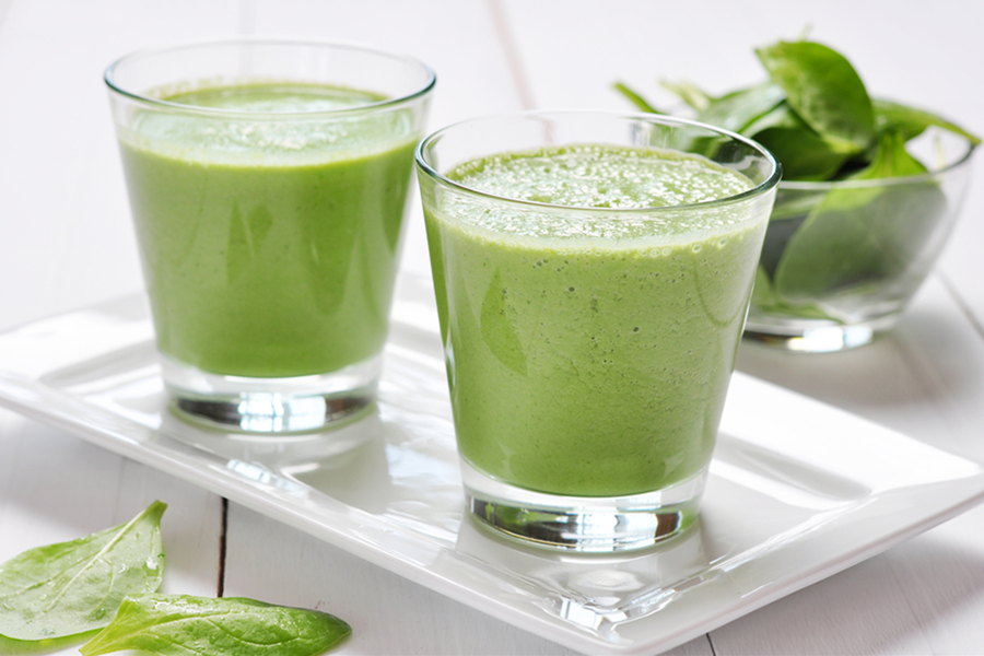 Two glasses of Sneaky Green Smoothie on a plate