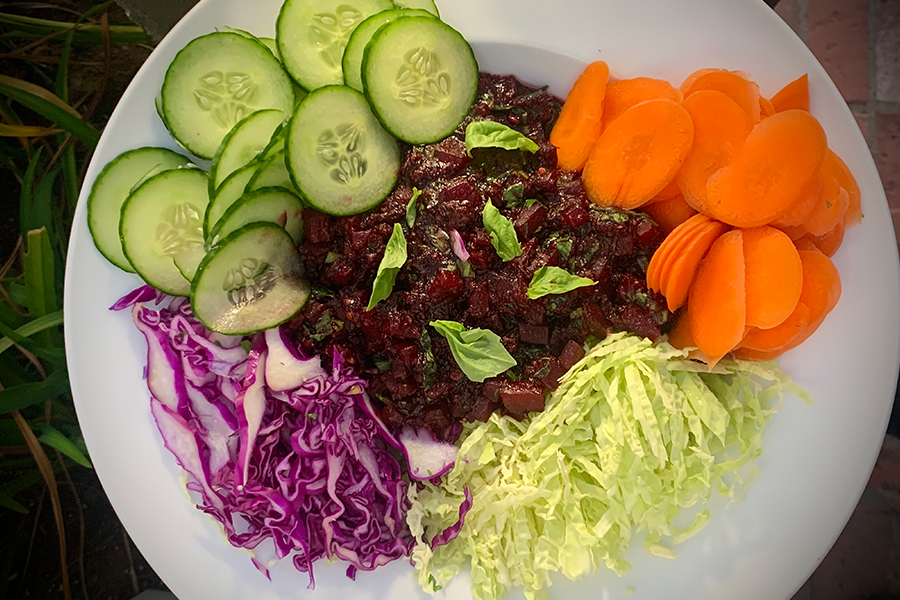 Plate of Beet Larb, carrots, cabbage and cucumber