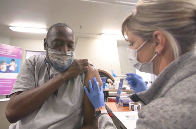 Elderly Black man gets vaccinated
