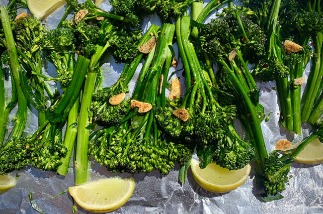Broccolini with Garlic, Chili Oil and Roasted Lemon on a baking sheet