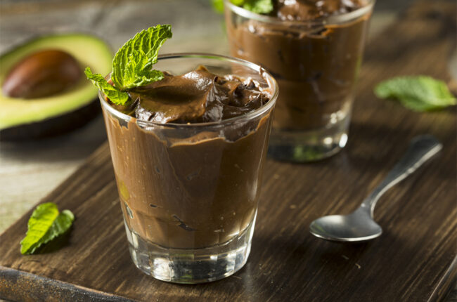 Chocolate-Avocado Pudding in a glass topped with mint leaves