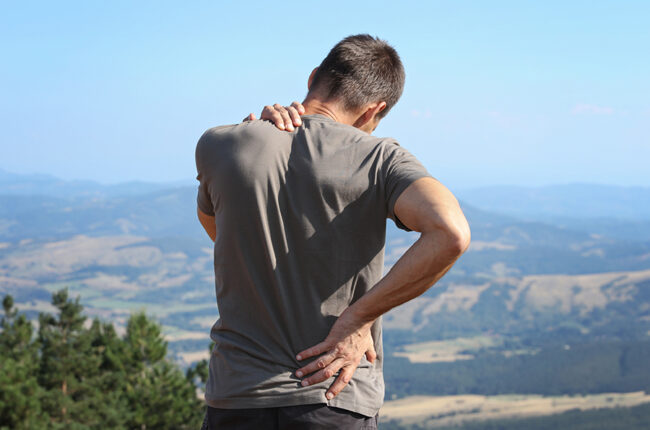 Man hiker with back pain