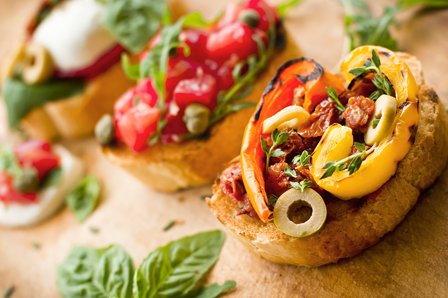 Bread slices topped with roasted bell peppers and tomatoes