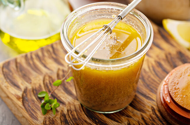Basic Vinaigrette in a jar with a whisk