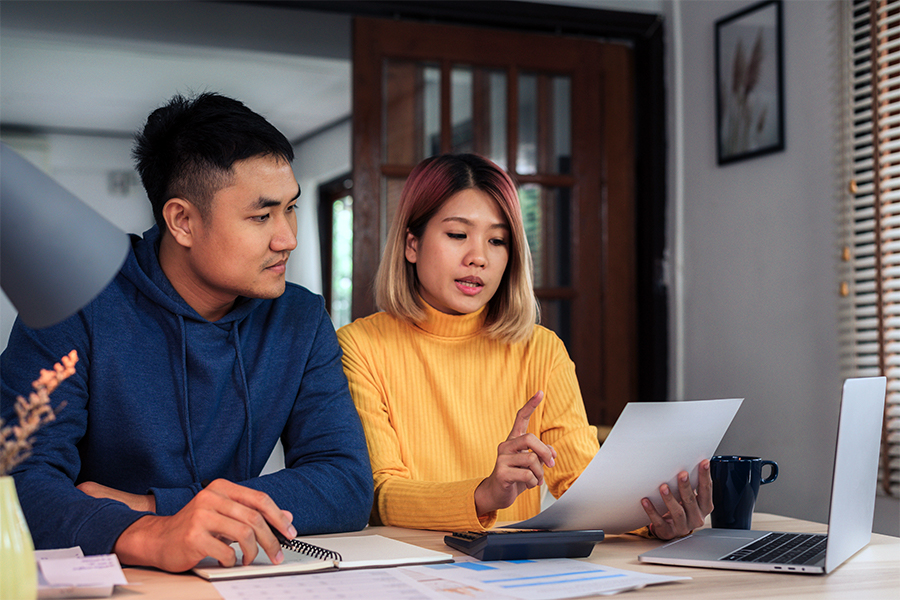 Young asian couple reviewing finances