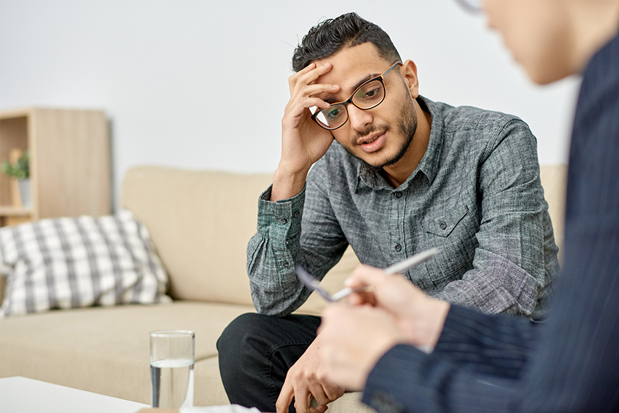 Man on cough talking to therapist