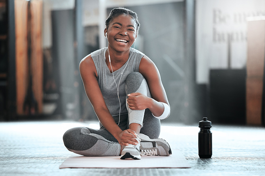 Gym, portrait or happy black woman on break after a workout, exercise or training for fitness. Funny, smile or healthy sports girl or female African athlete smiling or relaxing with positive mindset