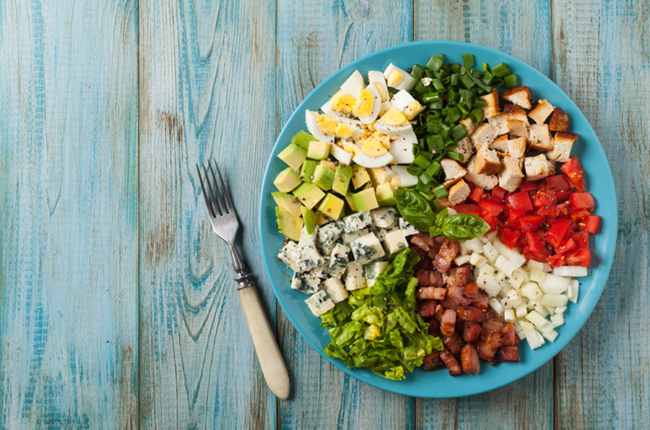 Cobb Salad with chicken, egg, avocado, tomatoes, cheese and other toppings