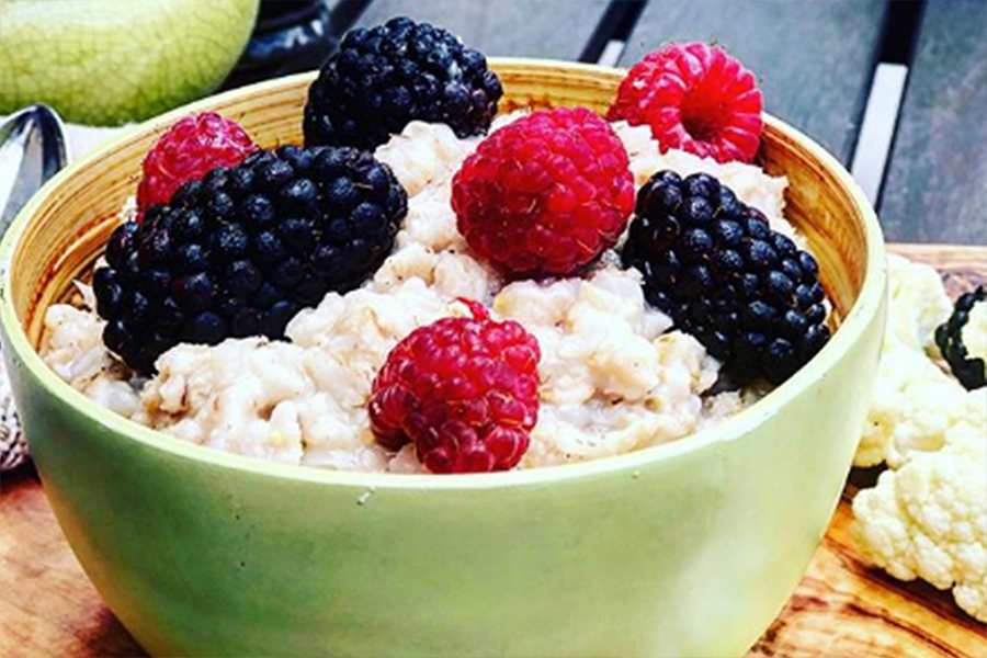Cauliflower Oatmeal in a bowl topped with blackberries and raspberries