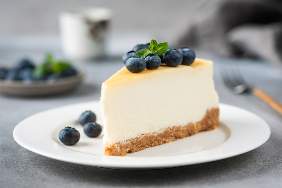 Slice of lemon cheesecake topped with blueberries