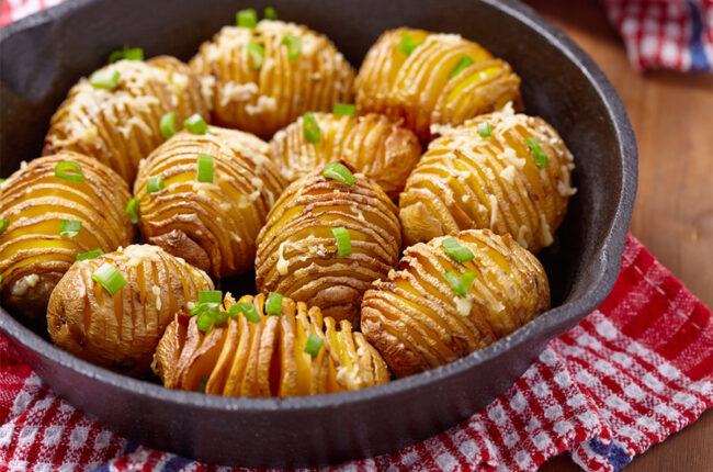 11 hasselback potatoes in a cast iron pan