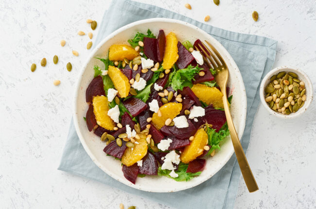 Salad with oranges, beets, seeds, and cheese