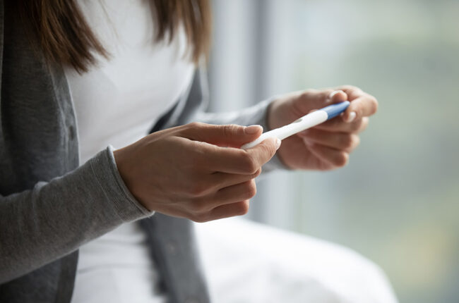 Woman checking pregnancy test