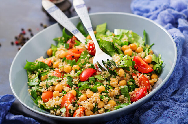Bowl of Quinoa Pesto Salad with Marinated Tomatoes and Chickpeas