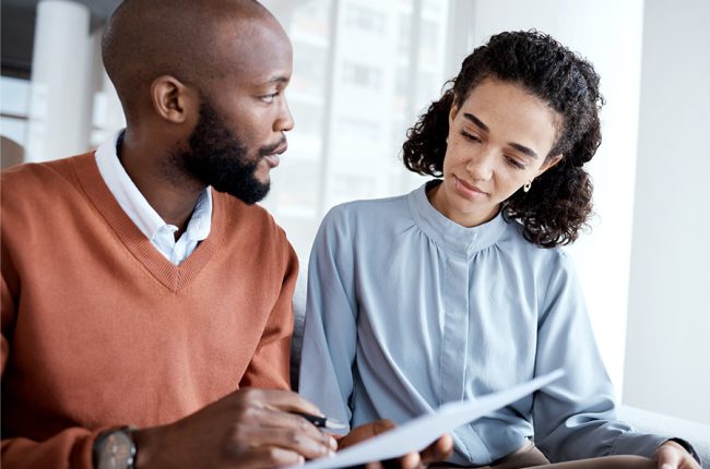 Man and woman looking over health insurance paperwork