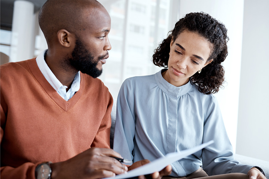 Man and woman looking over health insurance paperwork