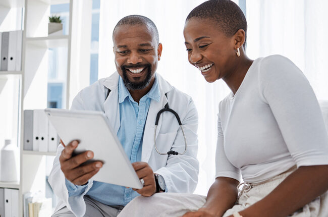 Doctor, healthcare and medicine with a patient talking test results and progress on a tablet in a hospital clinic. Trust, help and medical consulting with a professional medicare worker in his office